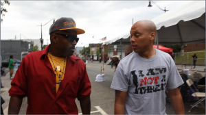 DoItAll & 24 Hours of Peace organizer, Hakim Green, on site at reading pop up stand. 